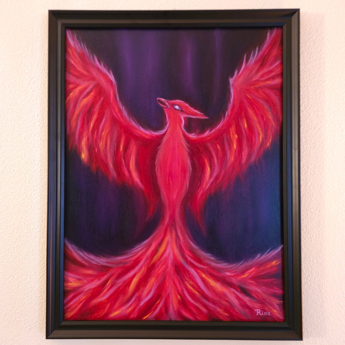 Framed oil painting of a phoenix with red and pink wings and a purple background