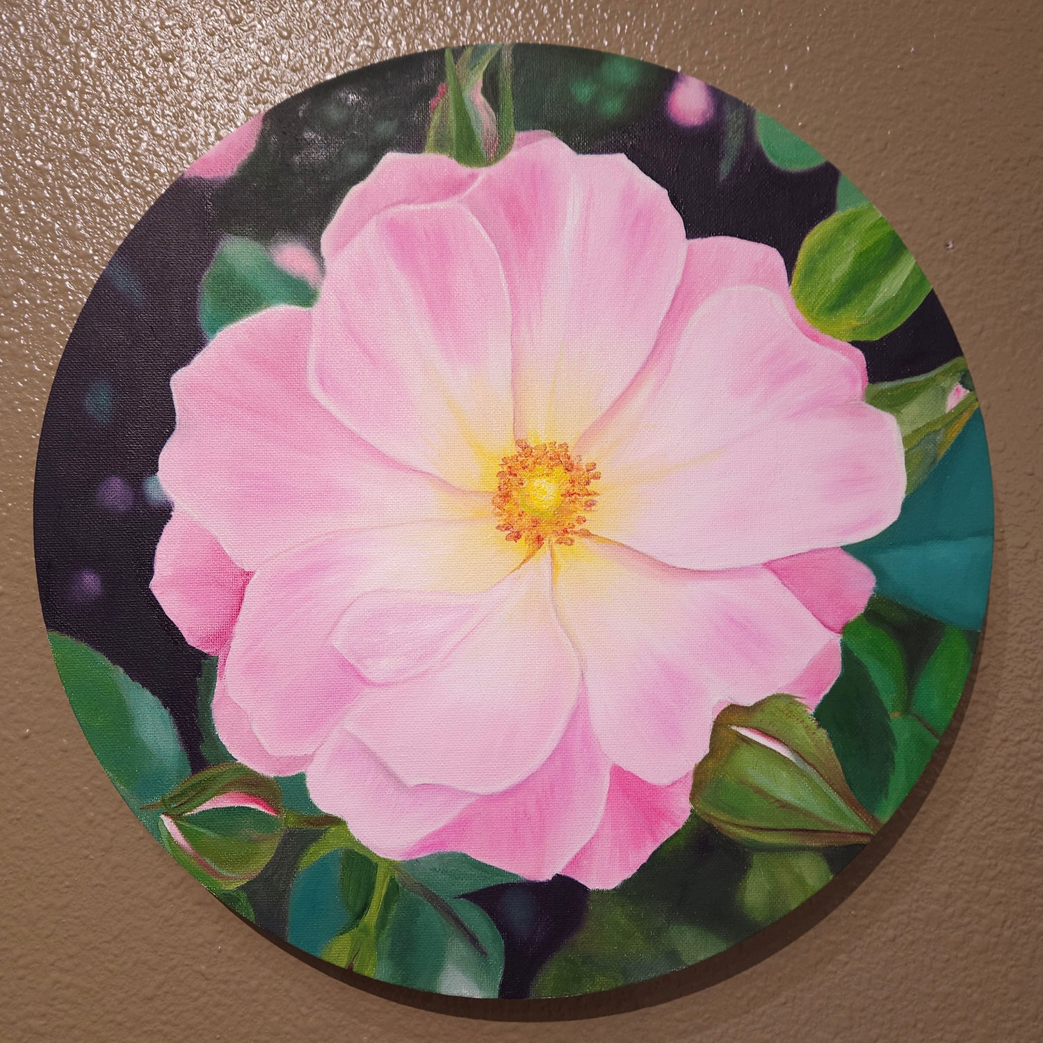 Close-up of a pink flower with green leaves on a circular canvas. 14x 14 Oil painting by Rissa. Roseandshadow.com