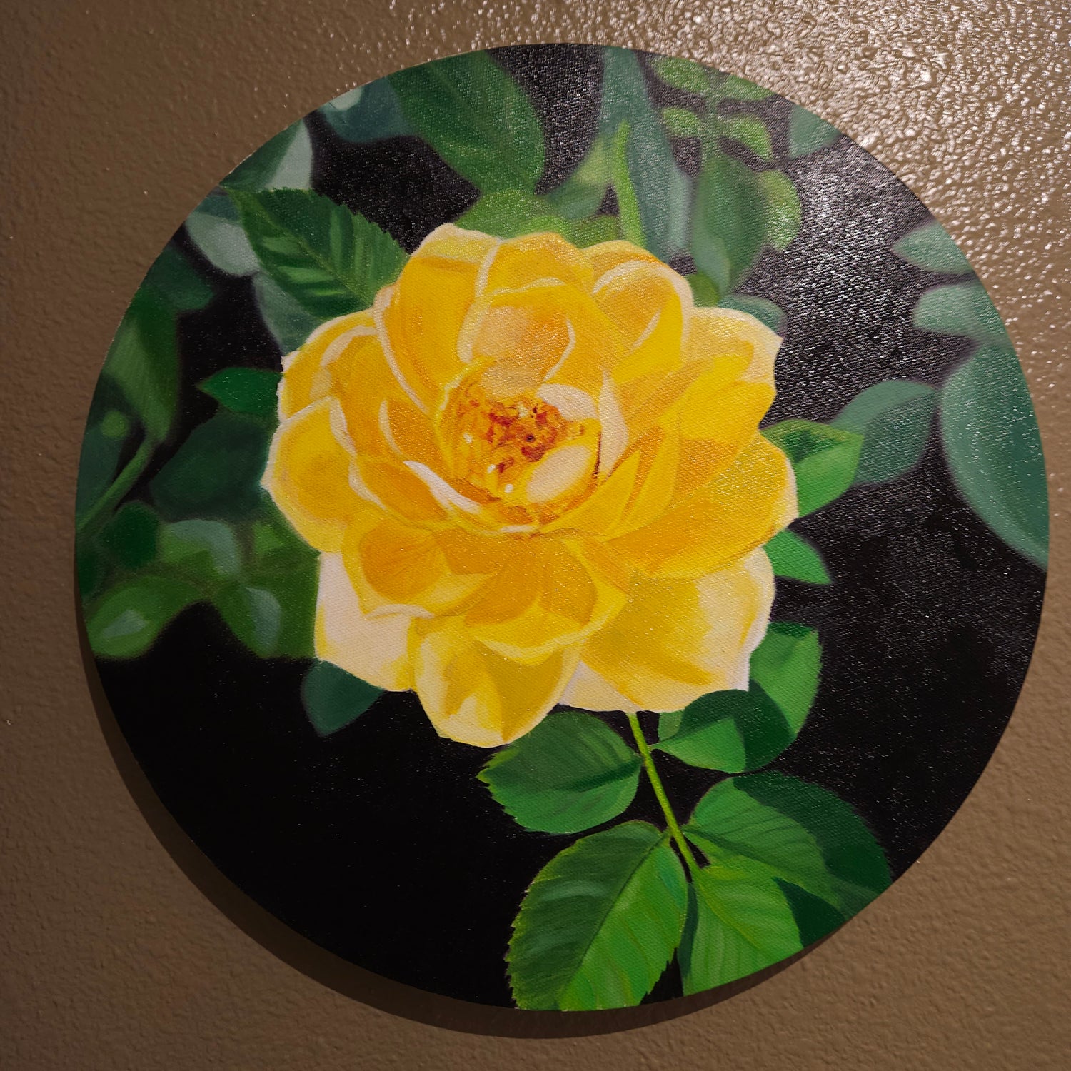 Close-up of a yellow rose with green leaves and black background on a round canvas. 14x 14 Oil painting by Rissa. Roseandshadow.com