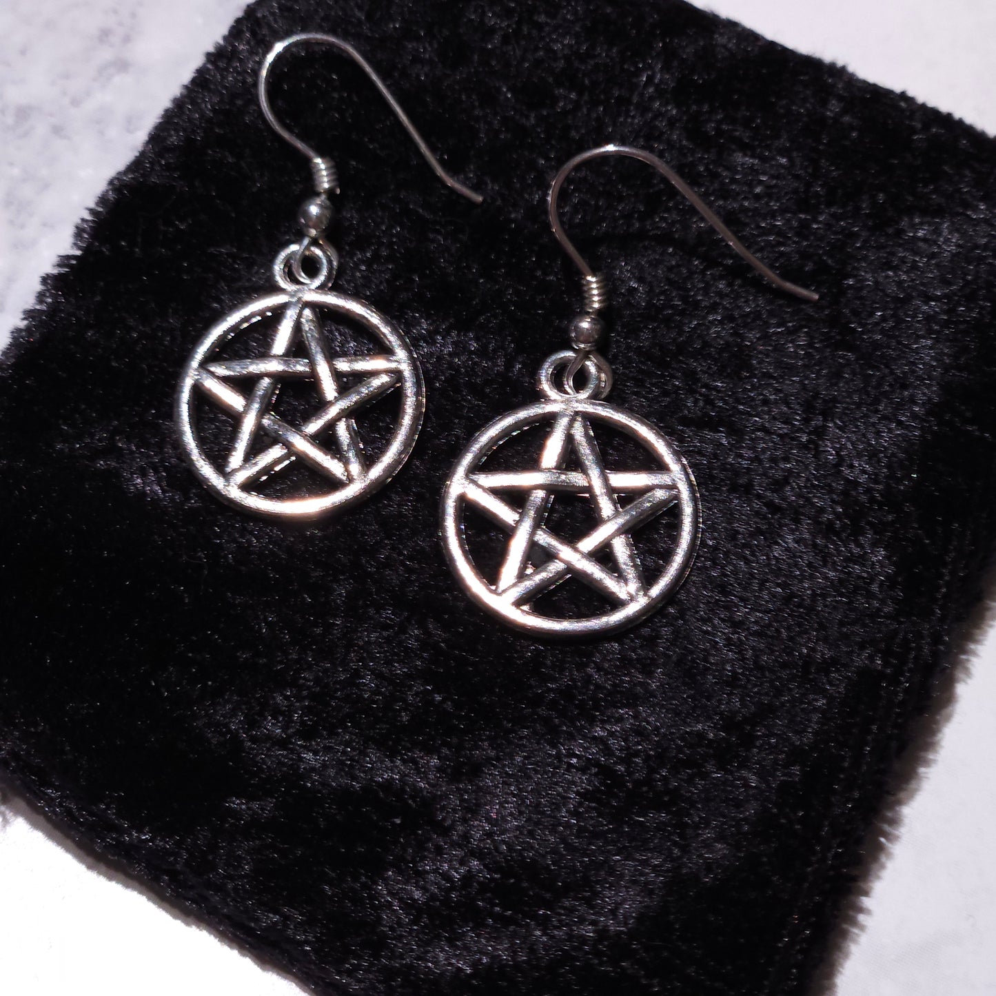 Pair of silver round pentacle charm earrings with pentagram dangle hooks