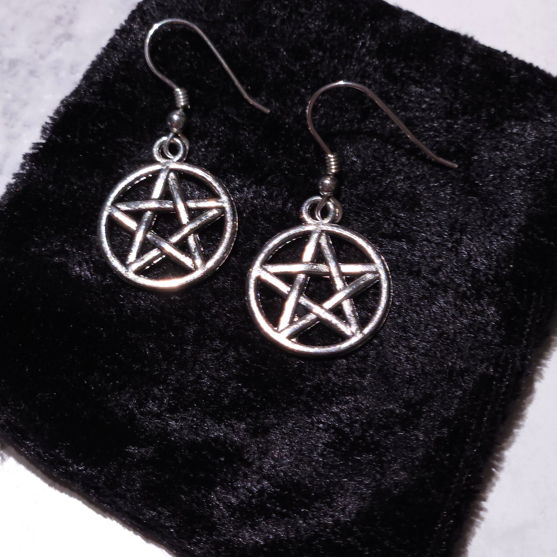 Pair of silver round pentacle charm earrings with pentagram dangle hooks
