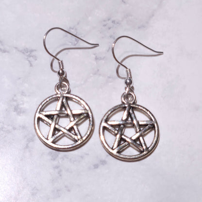 Silver pentagram charm earrings with dangling circular pendants and hook backs