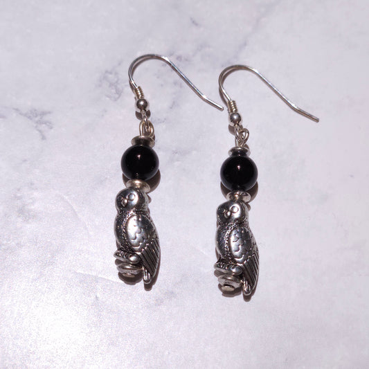 Silver-tone owl charm earrings with black bead drops and curved fishhook ear wires